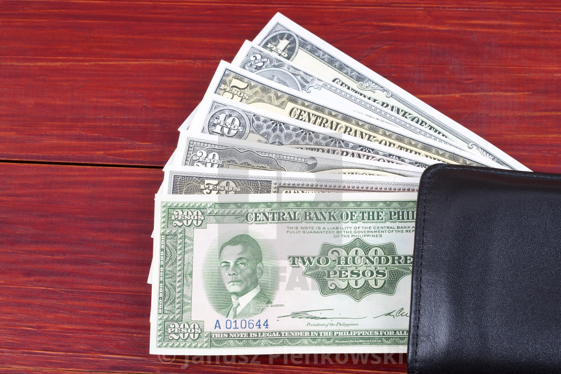 "Old Philippine peso in the black wallet" stock image