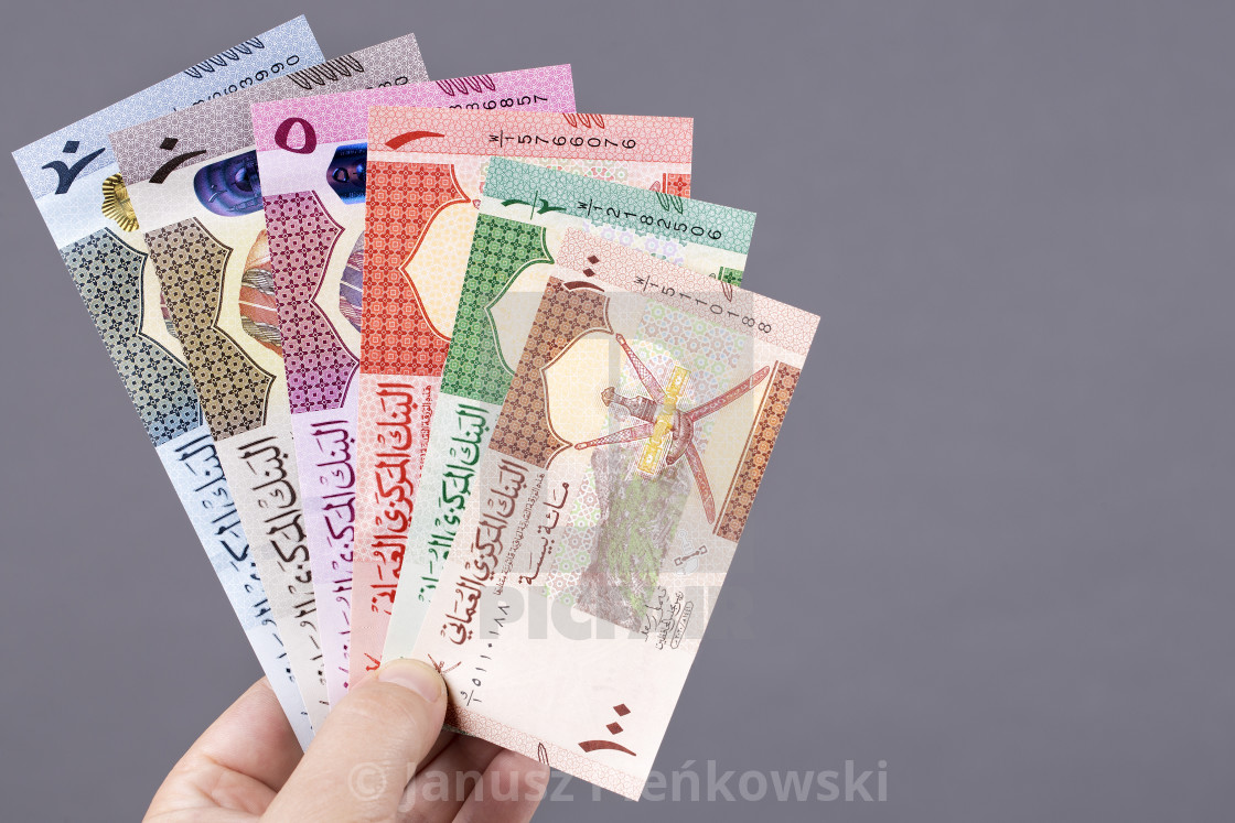 "Omani money in the hand on a gray background" stock image