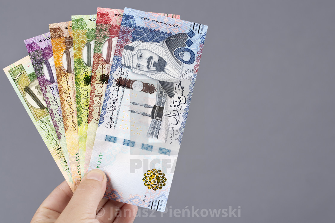 "Saudi money in the hand on a gray background" stock image