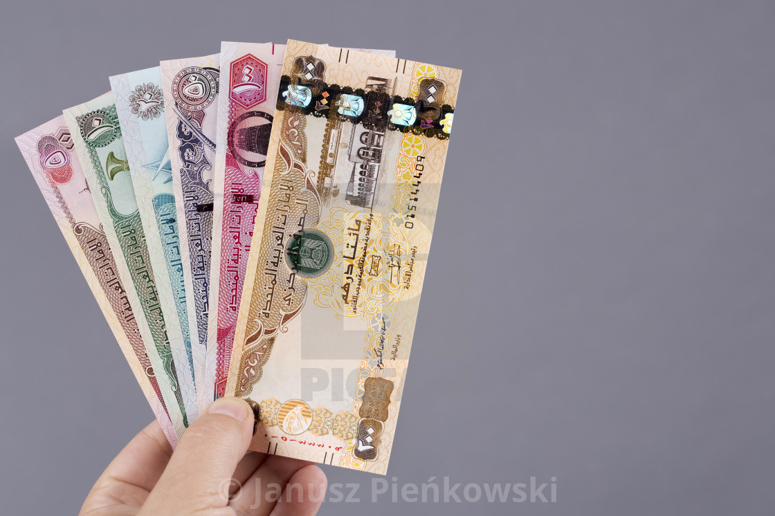 "United Arab Emirates money in the hand on a gray background" stock image