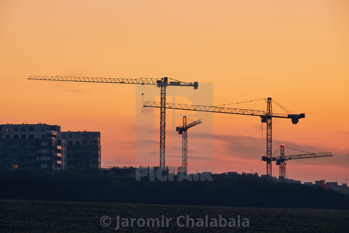 "Building activity on contruction site at sunrise" stock image