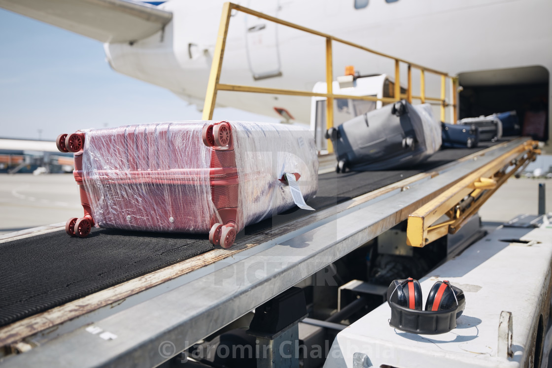 "Loading of luggage to airplane" stock image