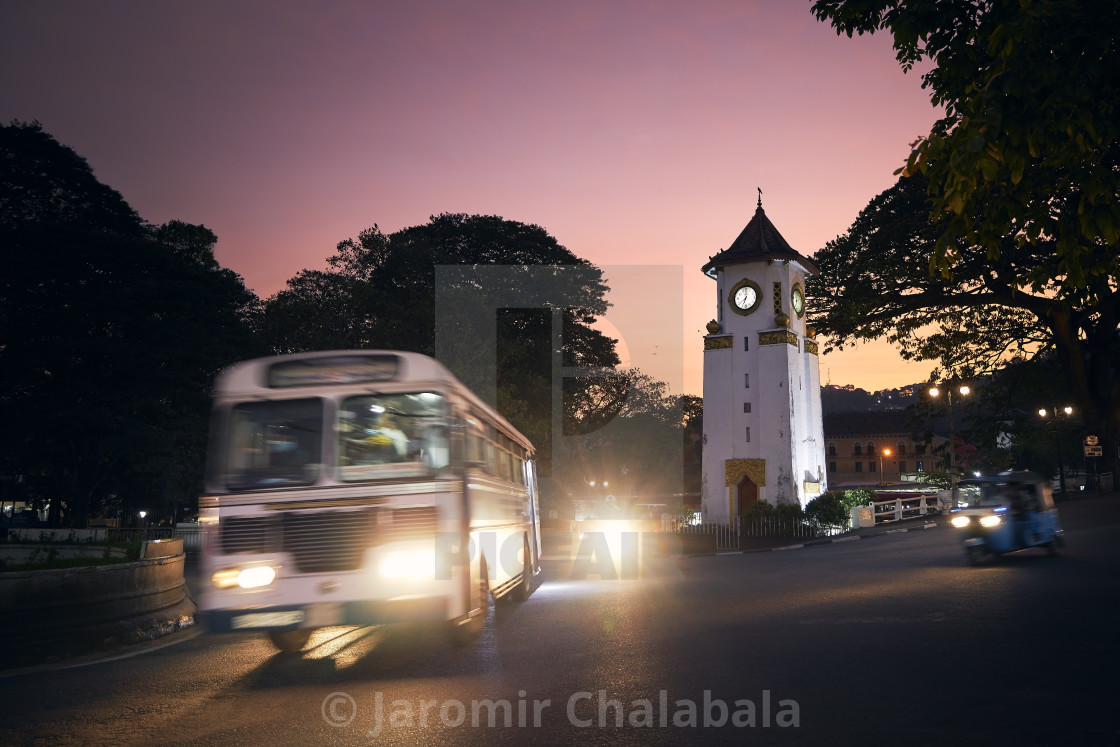 "Bus and tuk tuk in crossroad at dusk in Sri Lanka" stock image