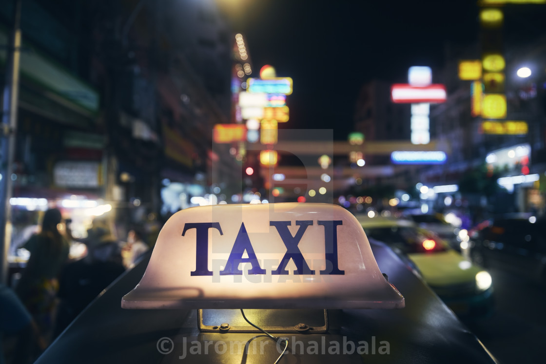 "Illuminated taxi sign on roof of tuk tuk" stock image