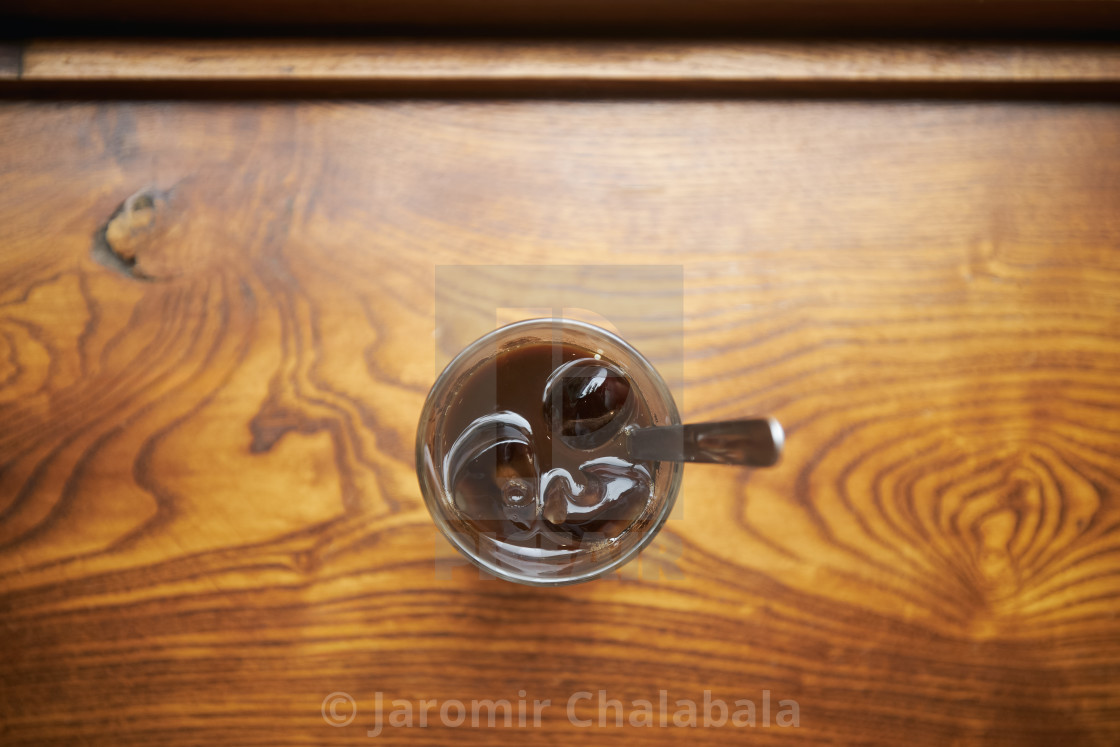 "Glass of Vietnamese iced coffee on wooden table" stock image