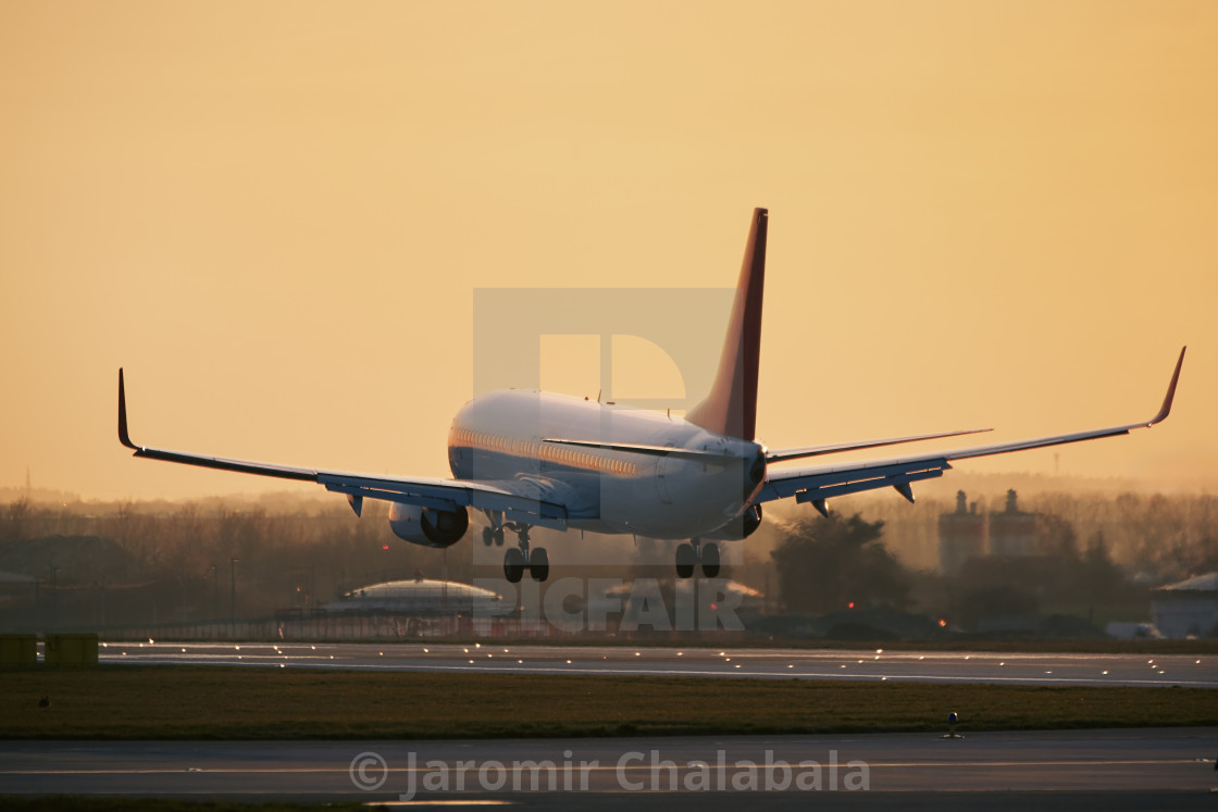 "Airplane approaching for landing on airport runway" stock image