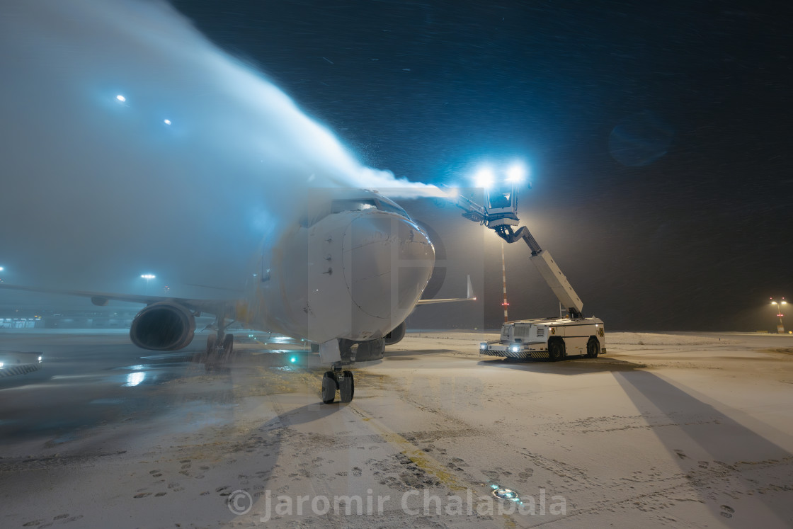 "Deicing of airplane at airport" stock image