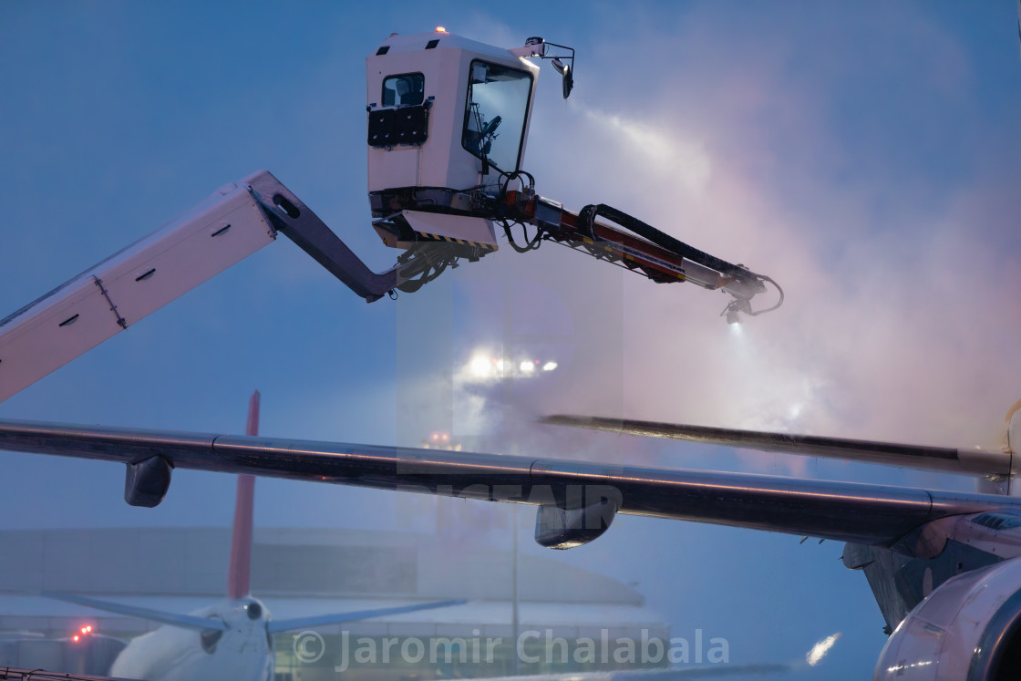 "Deicing of airplane at airport" stock image