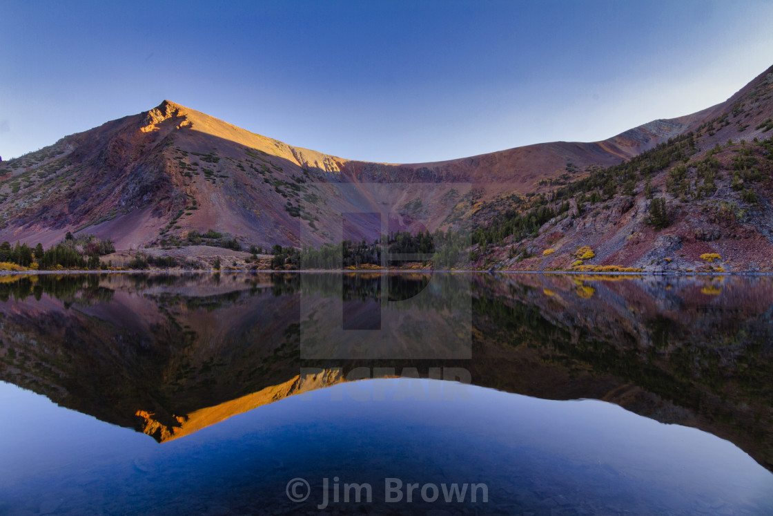 "Autumn reflection of a vibrantly colored mountain" by Jim Brown - £15.00 "Autumn reflection of a vibrantly colored mountain" stock image