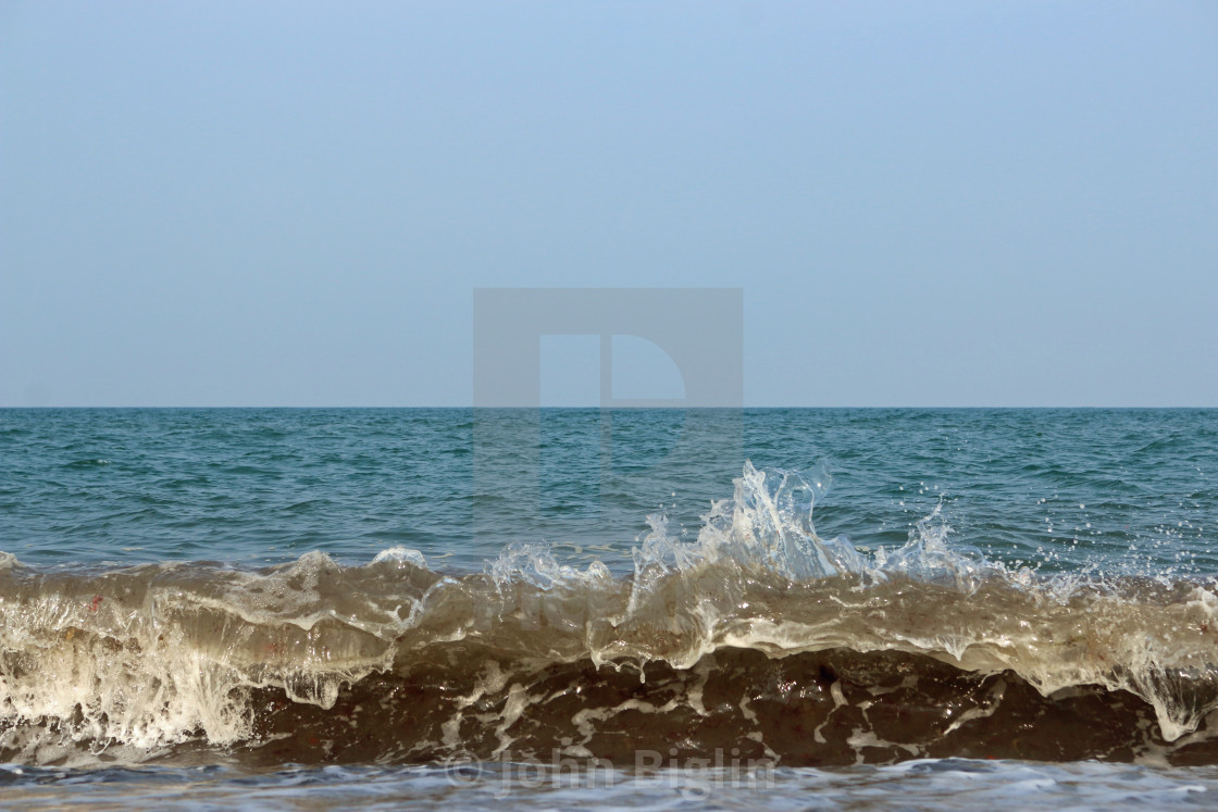 "Wave breaking on the beach" stock image