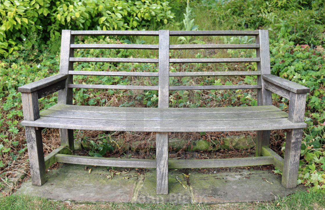 "Park seat surrounded by plants" stock image