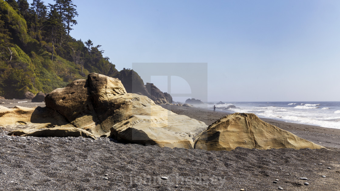 "Eroded Rocks Jut Out of the Beach" stock image