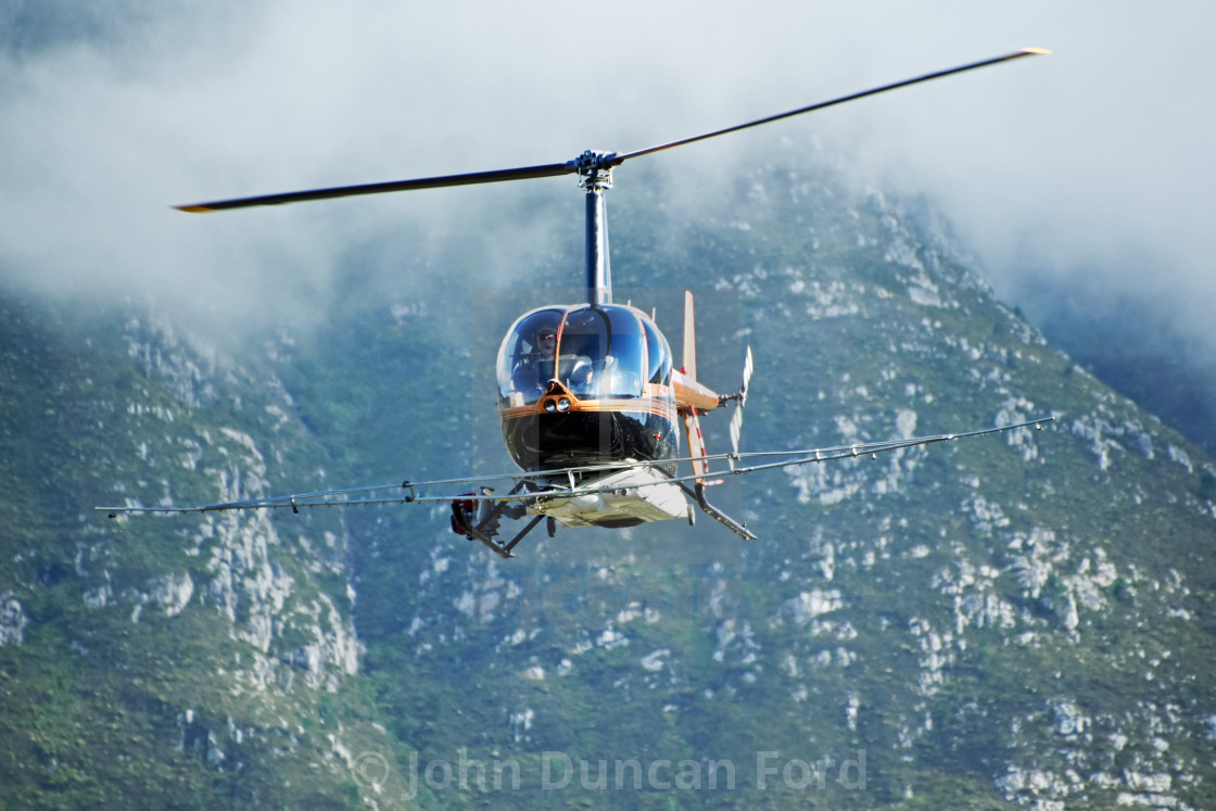 "Robinson R44 crop-spraying helicopter" stock image