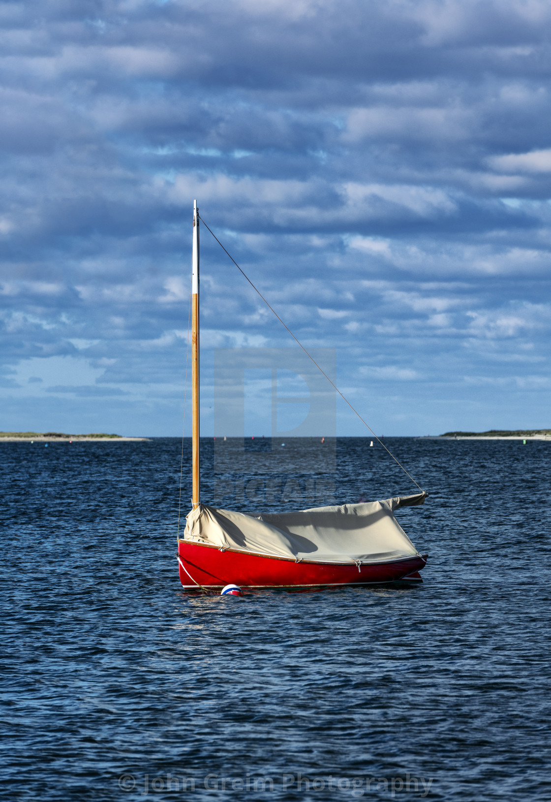 "Red sailboat anchored in Chatham Harbor" stock image