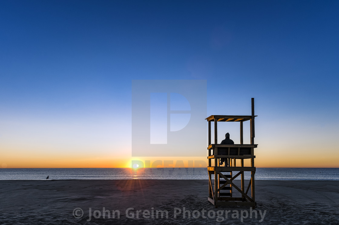 "Solitary person watches the ocean sunrise, Cape Cod" stock image