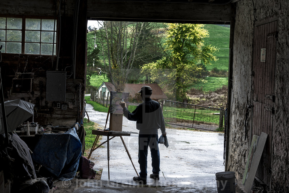 "Artist paints a rural landscape from a barn" stock image