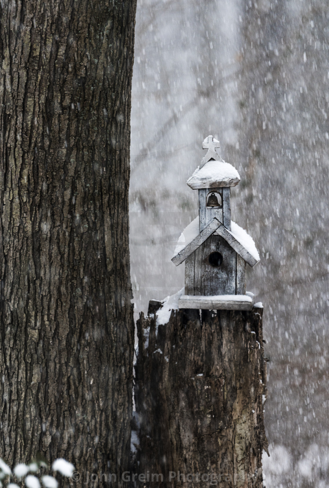 "Charming birdhouse chapel in a winter snow" stock image