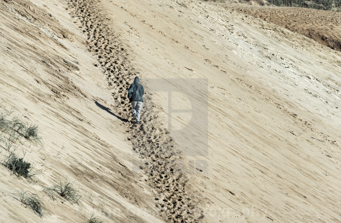 "Jogging a steep dune path" stock image