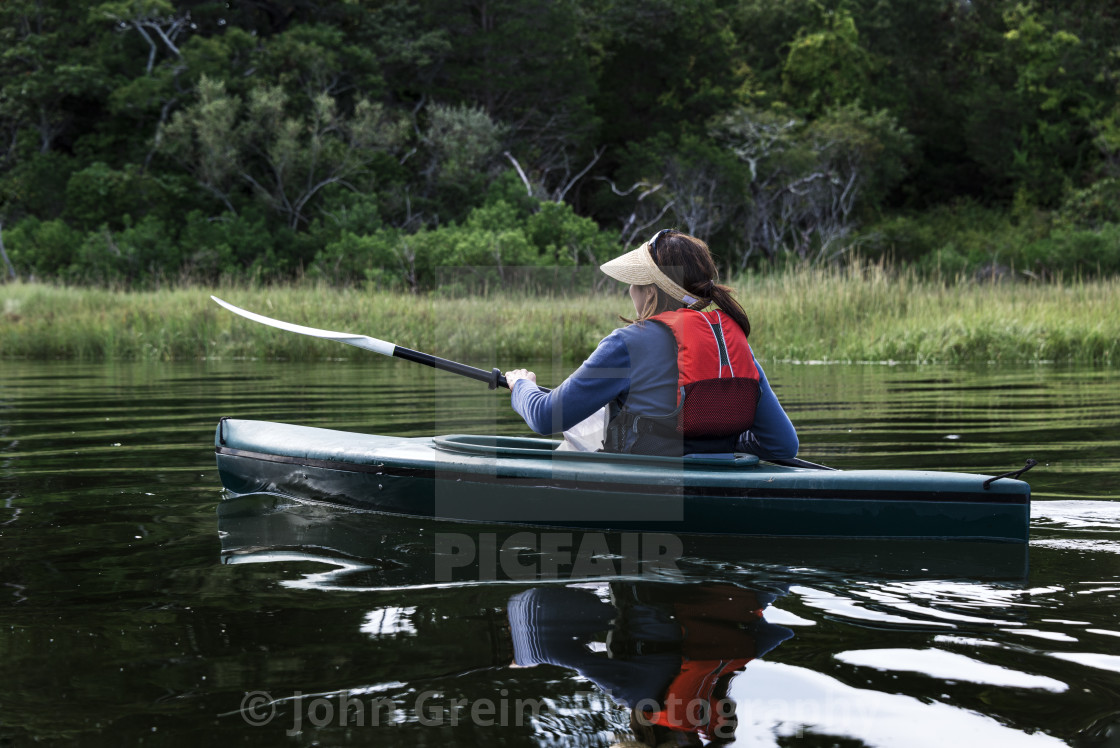 "Mature woman sightseeing from a kyak" stock image