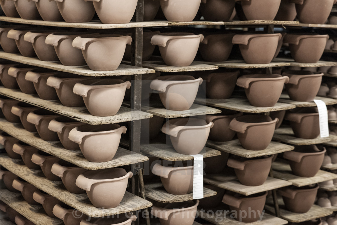 "Unfinished clay cups ready for glazing" stock image