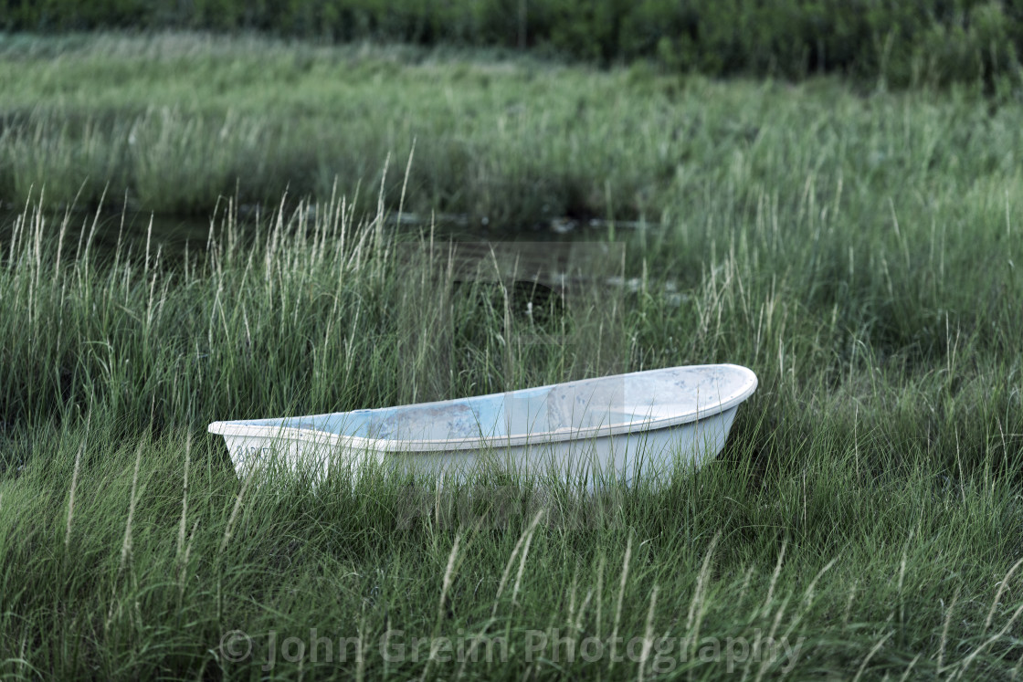 "Rowboat moored in marsh grass" stock image