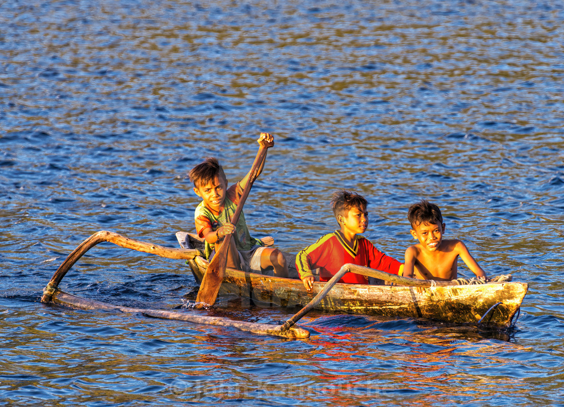 "Boys in Wooden Outrigger Canoe" stock image