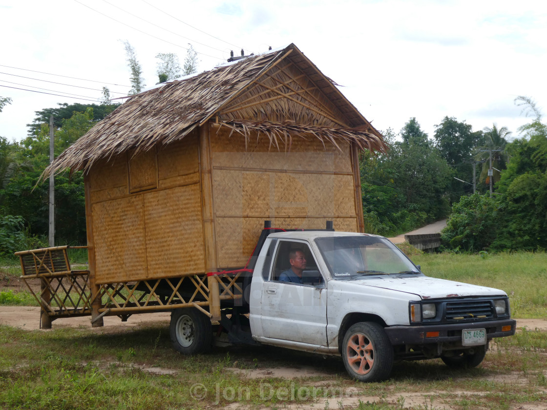 "Moving a new hut the hard way. Thailand" stock image