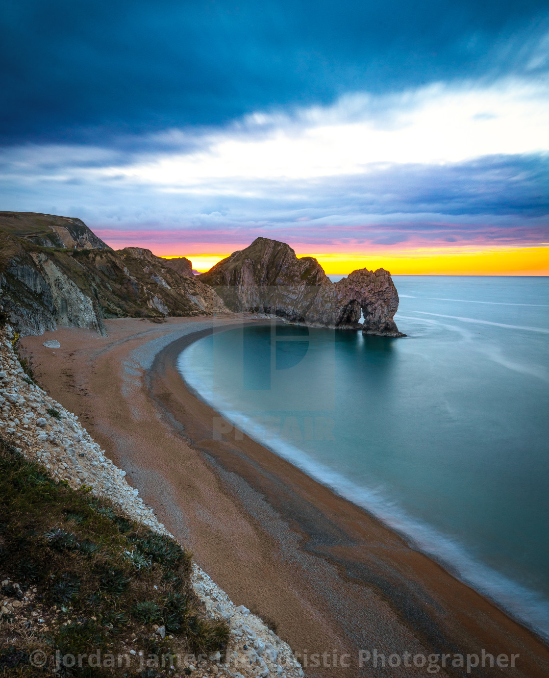 "Durdle Door sunrise" stock image