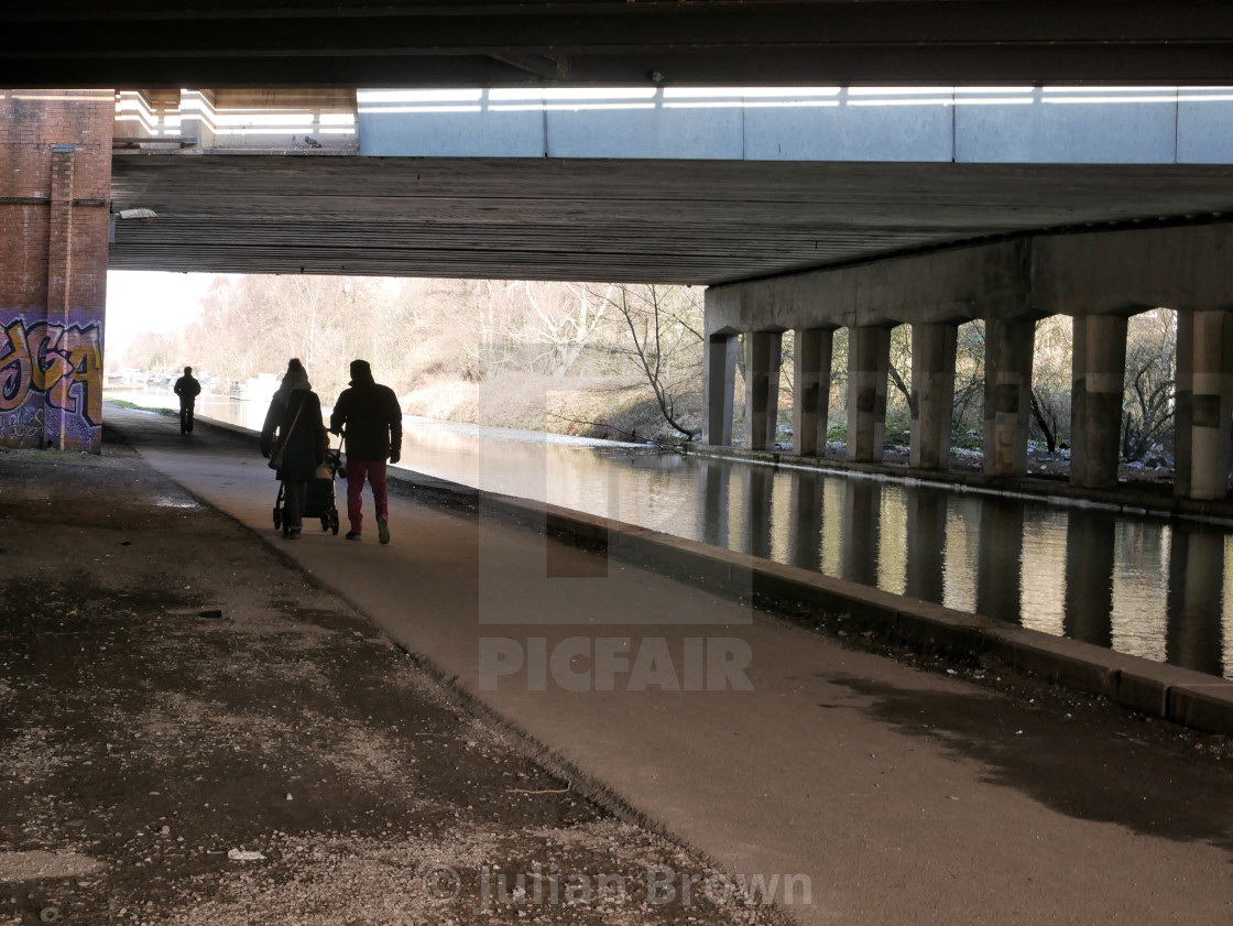 "Stretford, Manchester, UK. 9 February 2021. Path used by walkers, runners and cyclists near the Bridgewater Canal. Credit: Julian Brown" stock image