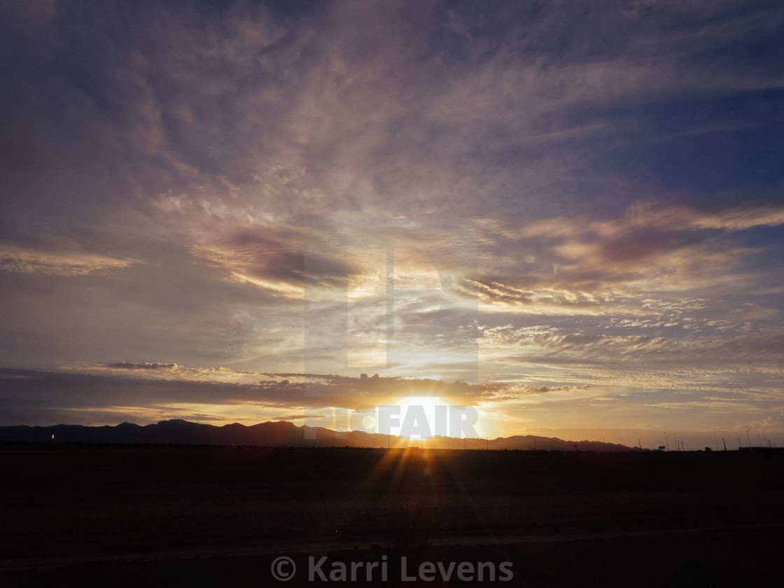 "Arizona Sunset With Sun & Clouds" stock image