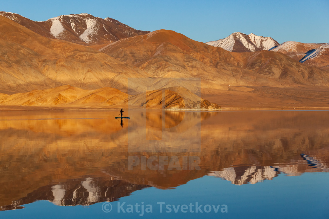 "SUP boarding Mirror reflection in calm lake." stock image