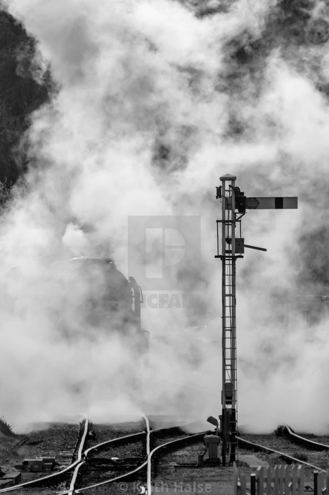 "Steam locomotive emerging from the smoke" stock image
