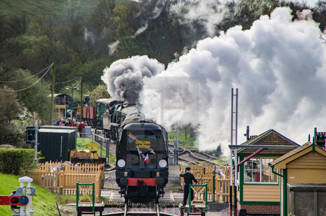 "Golden Arrow steam locomotive at a level crossing" stock image