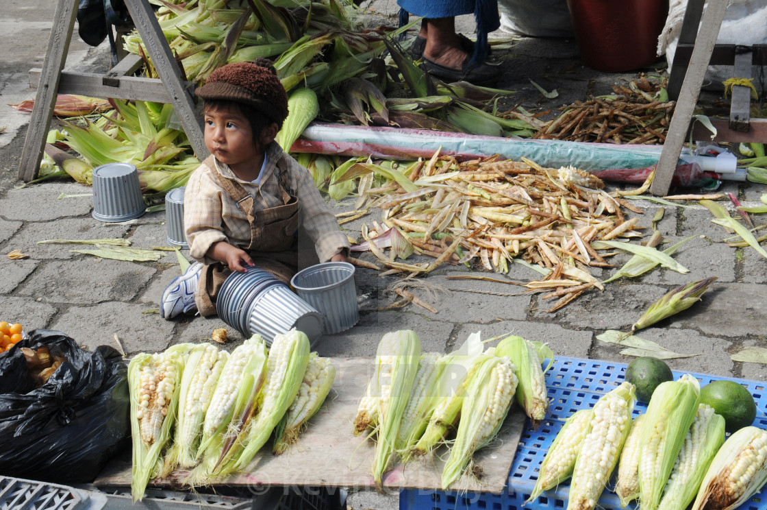 "Child and corn husks. Vegetable Market, Otavalo, Ecuador" stock image