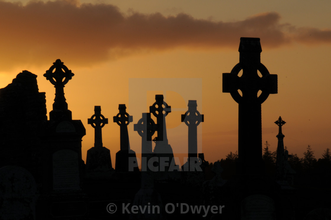 "Clonmacnoise grave yard at sunset" stock image