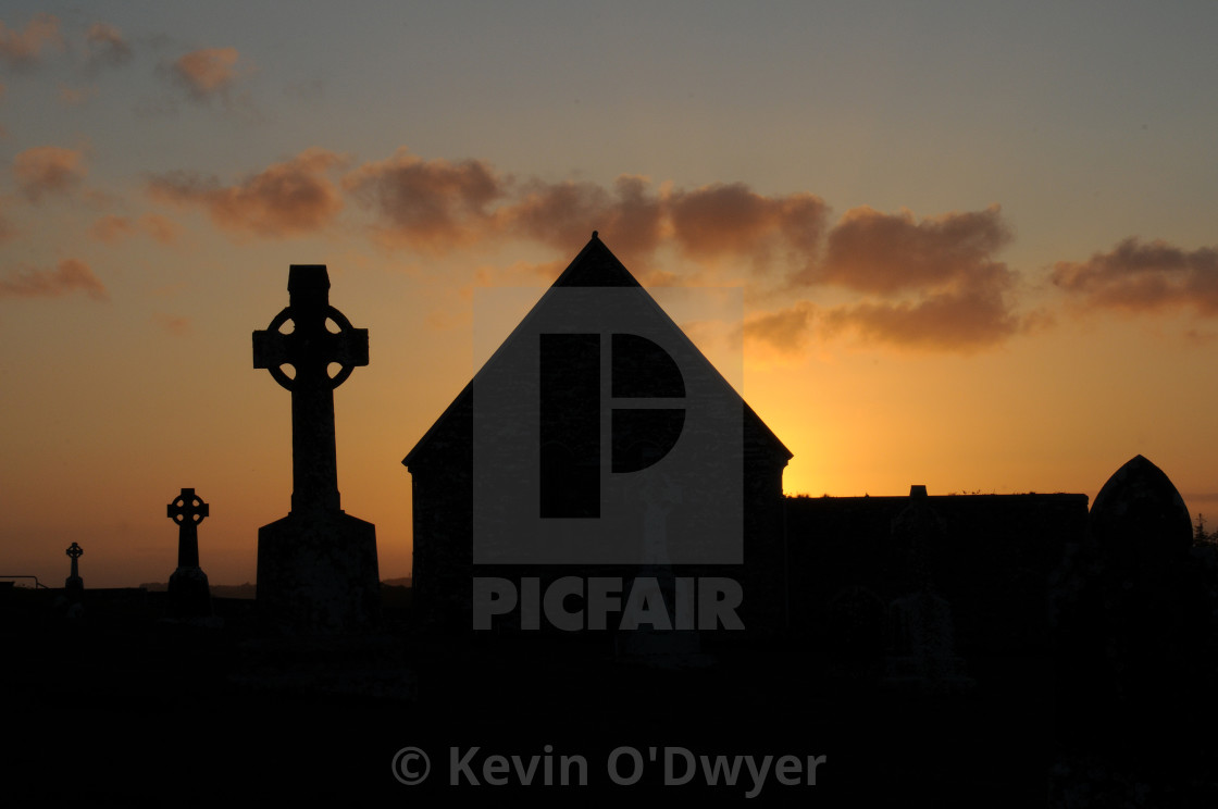 "Clonmacnoise grave yard at sunset" stock image