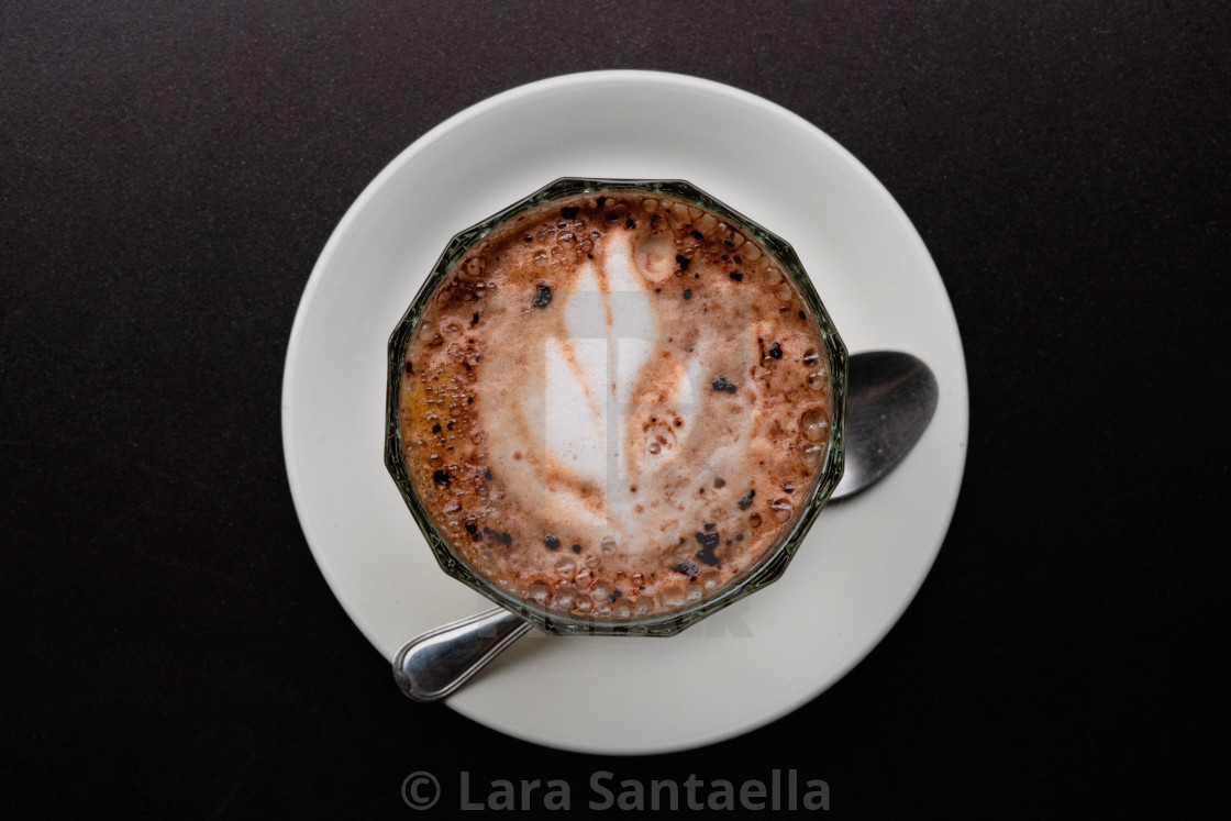 "A cup of coffee on its dish" by Lara Santaella - $56.56 "A cup of coffee on its dish" stock image