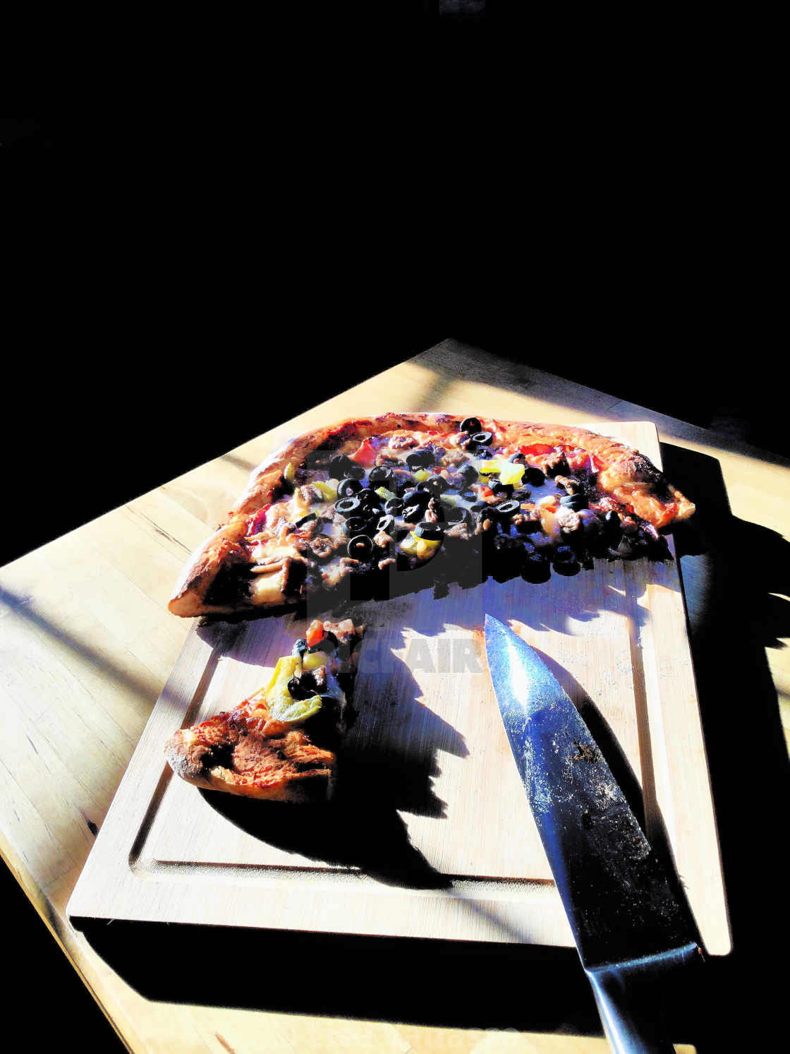 "A homemade pizza with his knife." by Lise Vanasse - £1.00 "A homemade pizza with his knife." stock image