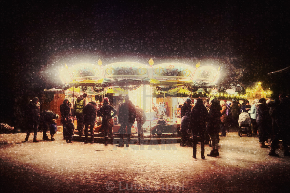 "Munich Christmas market at night: snowfall reflecting on the lights of a..." stock image