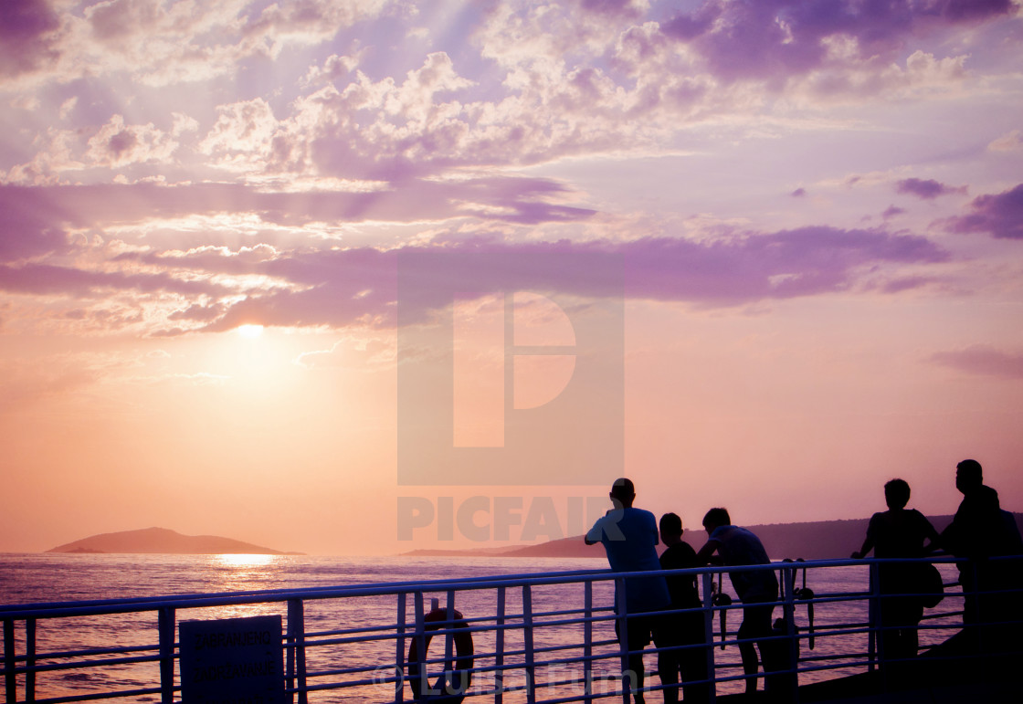 "Croatia, Dalmatian coast: People on a ferry looking at sunset" stock image