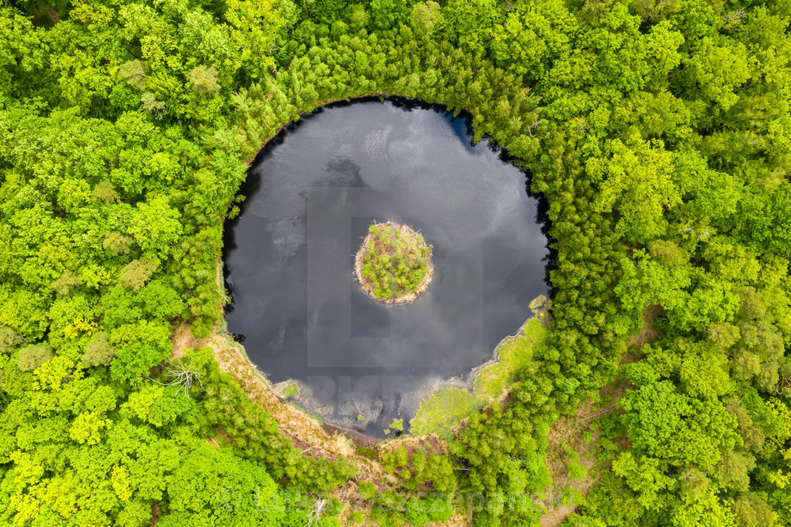 "Round lake with island in the middle among forest, aerial view" by Lukasz Szczepanski - £12.79 "Round lake with island in the middle among forest, aerial view" stock image