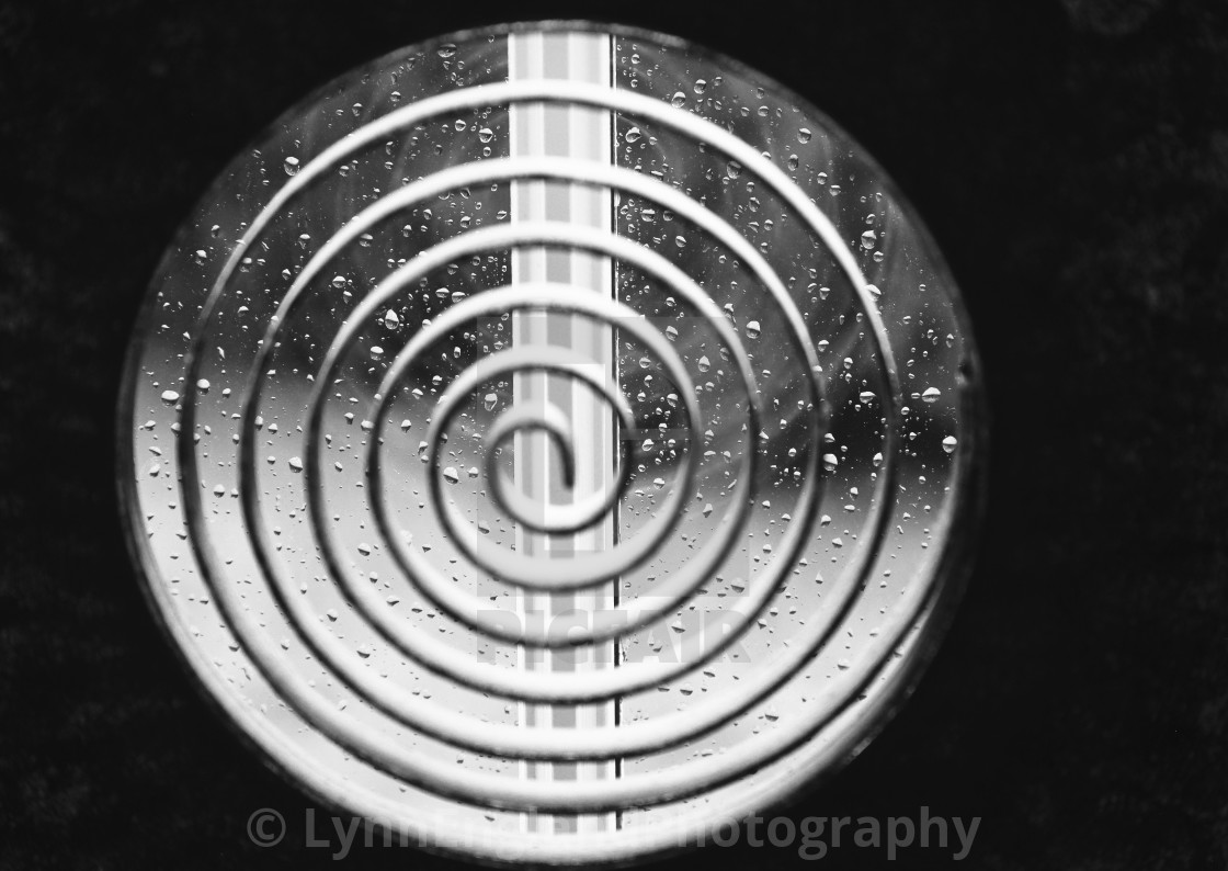 "Monochrome Lockdown spiral.....raindrops on a window via a spiral sculpture" stock image