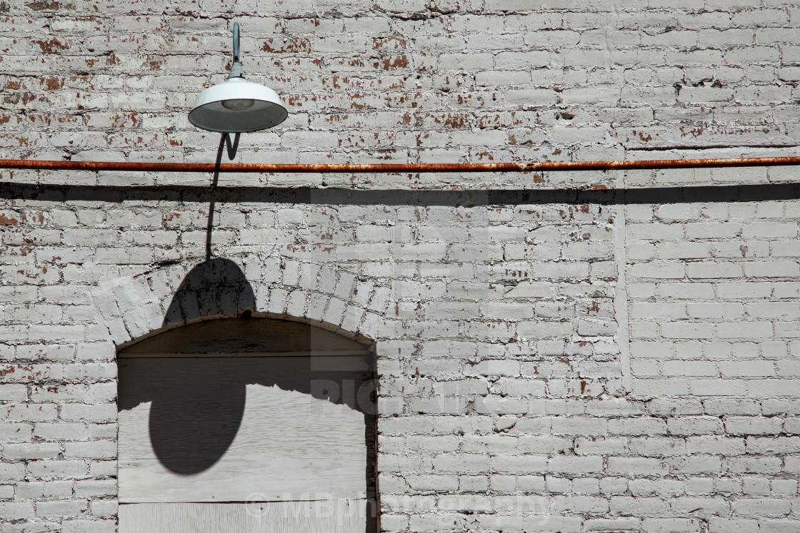 "Brick wall with a lamp and copy space" stock image