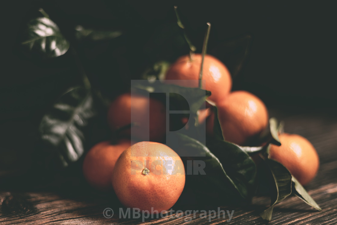 "Fresh tangerines with leaves on a wooden background" stock image