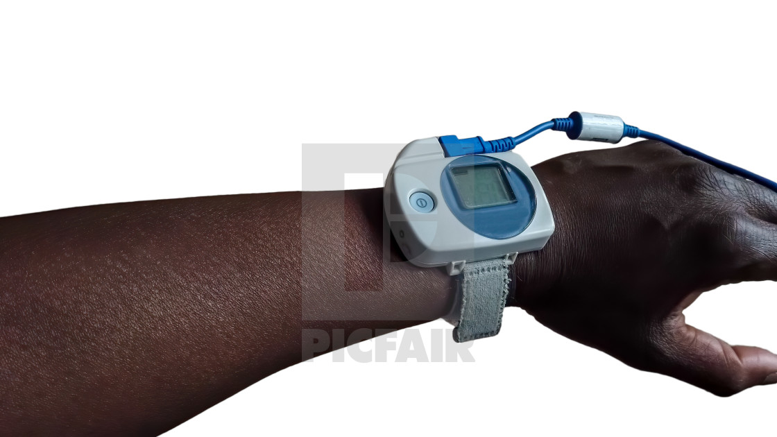 "Sleep pulse oximeter on the arm of a black man" stock image