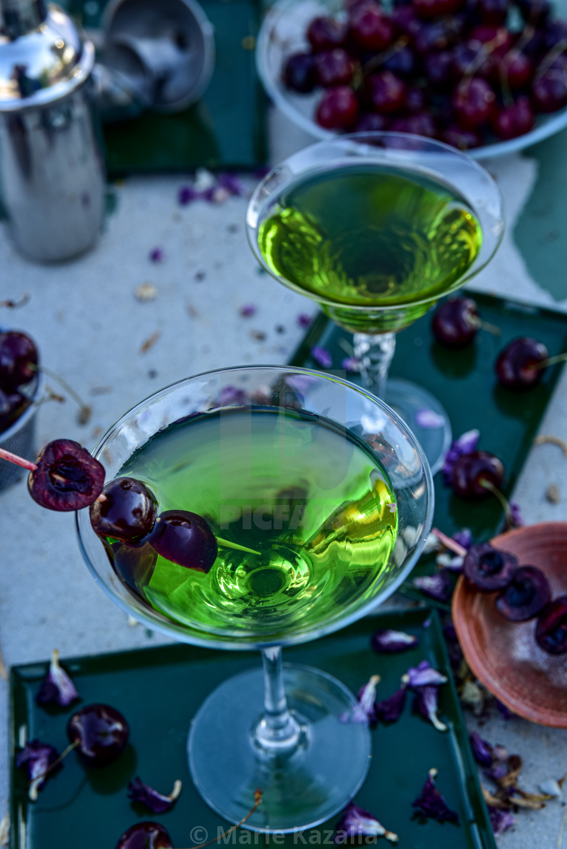 "close view of filled stemware martini cocktail drink glass" by Marie Kazalia - $15.44 "close view of filled stemware martini cocktail drink glass" stock image