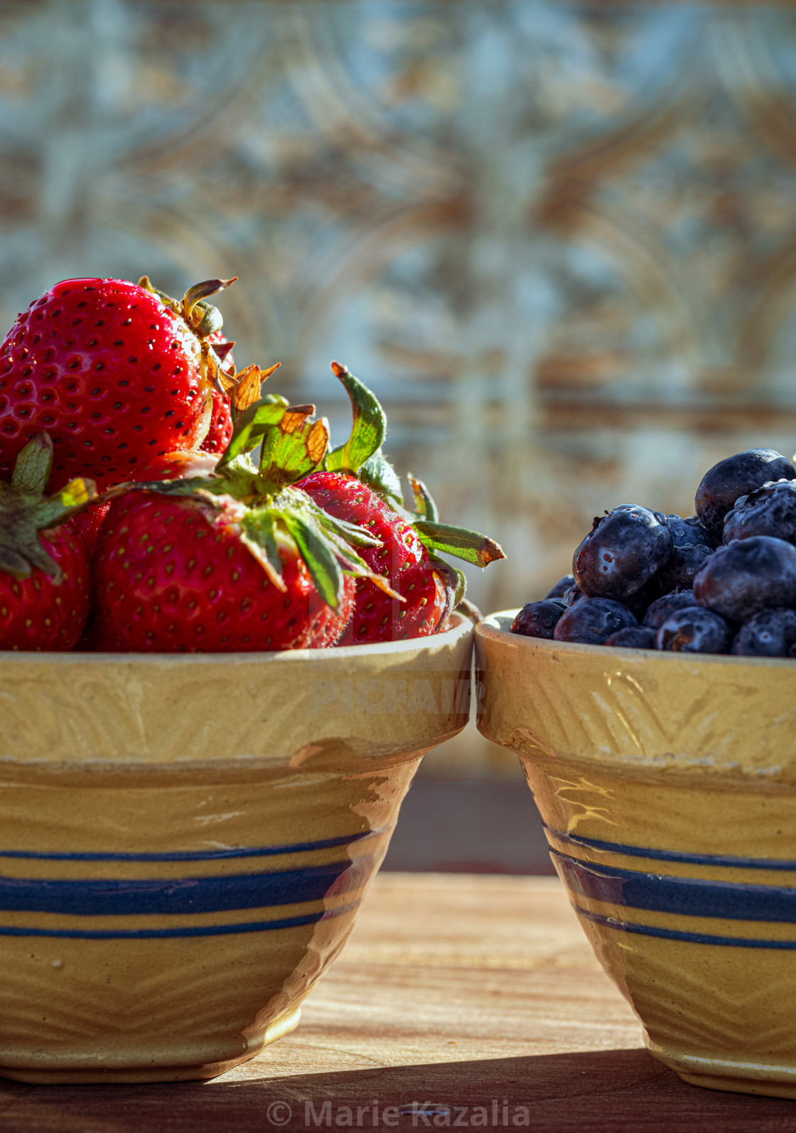 "vintage clay kitchen bowls filled with strawberries and blueberries" by Marie Kazalia - $15.16 "vintage clay kitchen bowls filled with strawberries and blueberries" stock image