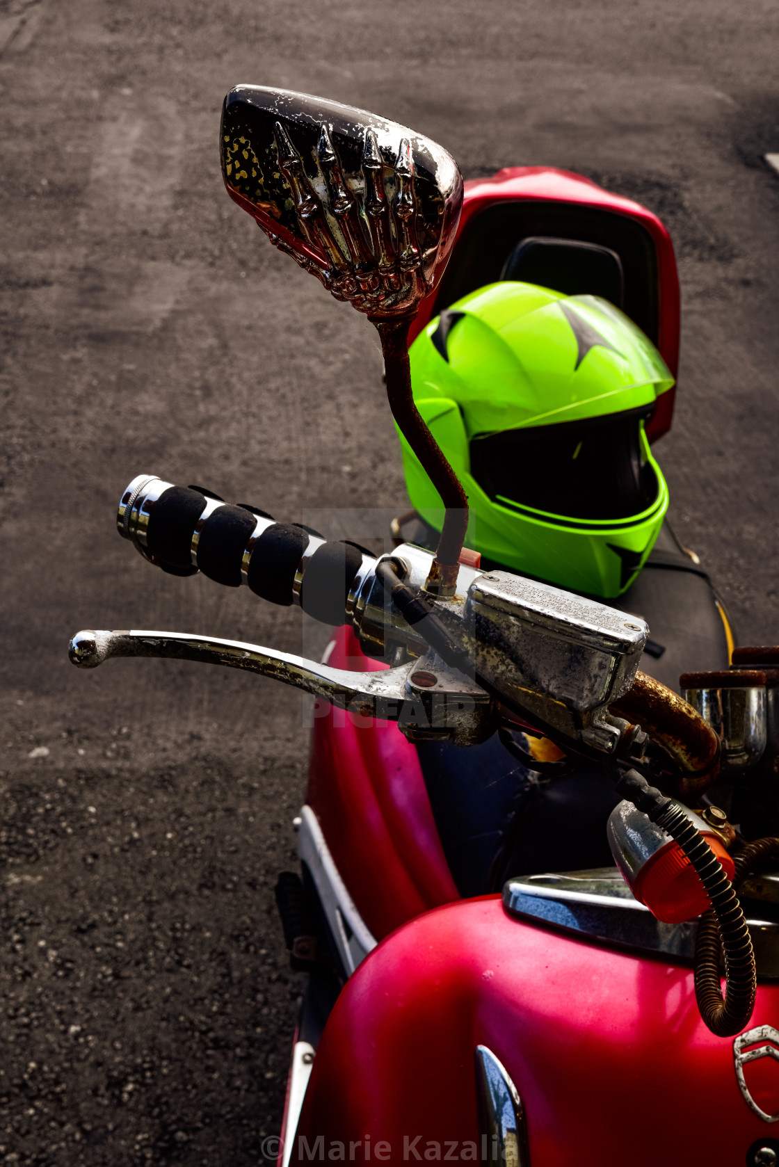 "Skeleton hand mirror with boney finger on red motor scooter" by Marie Kazalia - $15.16 "Skeleton hand mirror with boney finger on red motor scooter" stock image