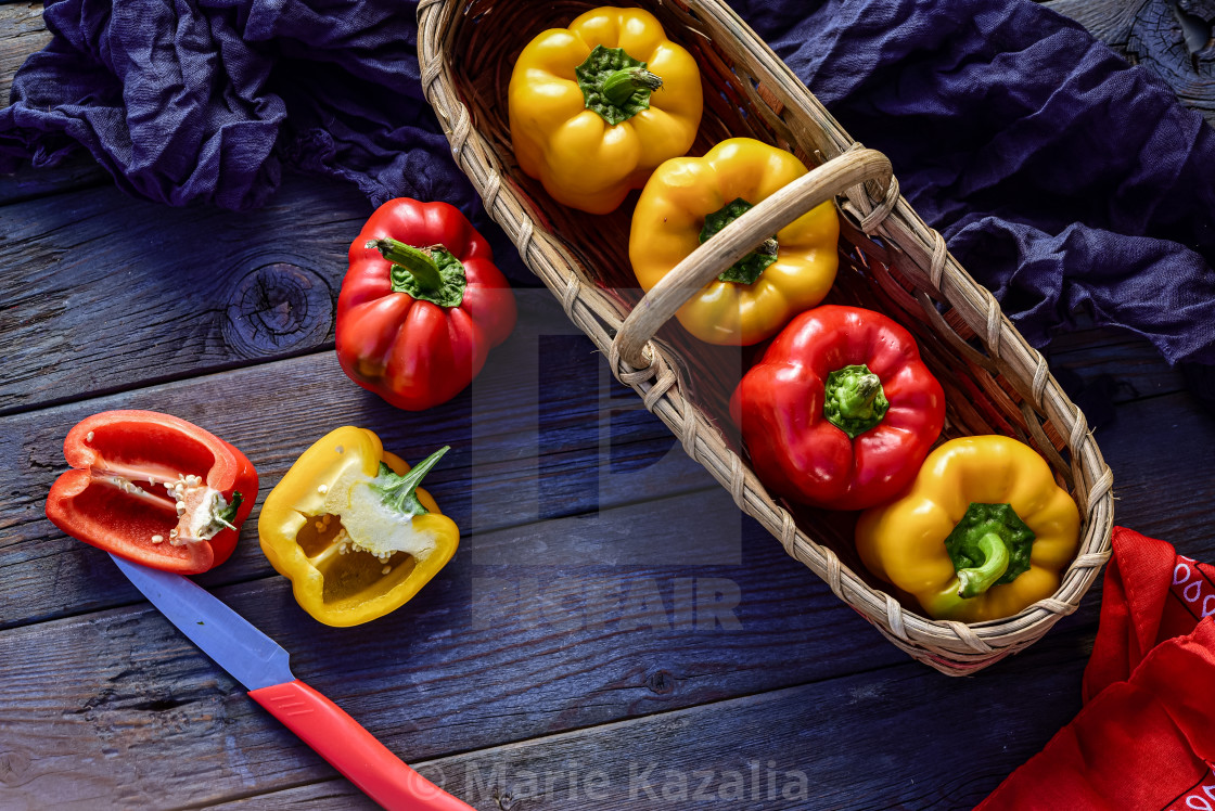 "red and yellow whole bell peppers in vintage basket and cut into halves" by Marie Kazalia - $15.16 "red and yellow whole bell peppers in vintage basket and cut into halves" stock image