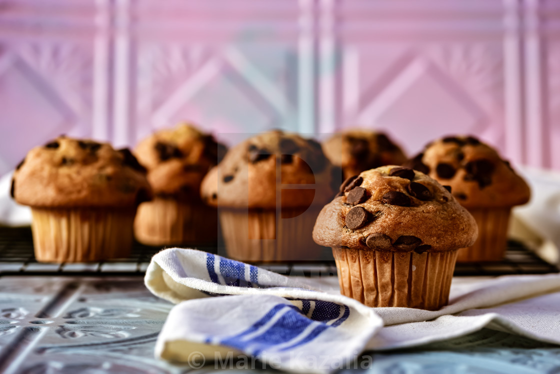 "chocolate chip muffins on kitchen counter cooling rack" by Marie Kazalia - $15.44 "chocolate chip muffins on kitchen counter cooling rack" stock image